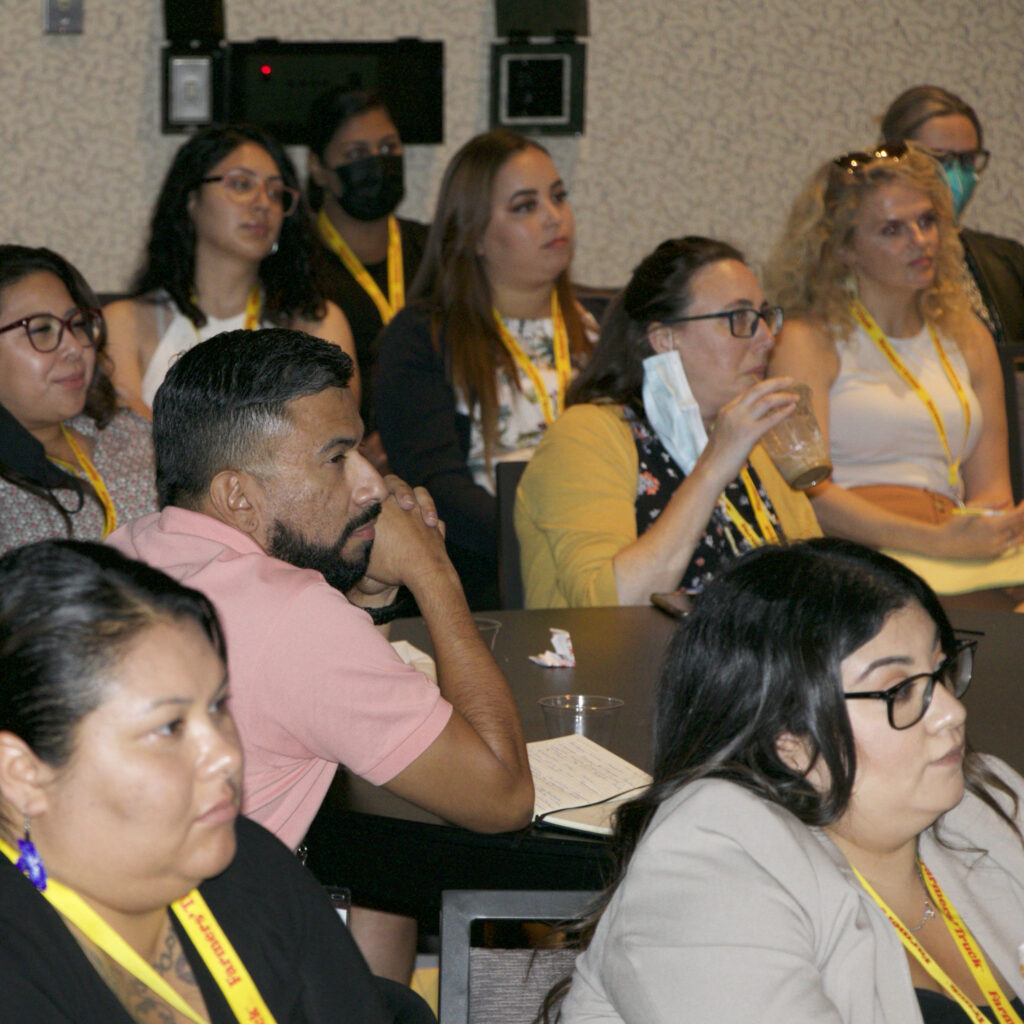 Picture of people sitting looking interested in the direction of a speaker.
